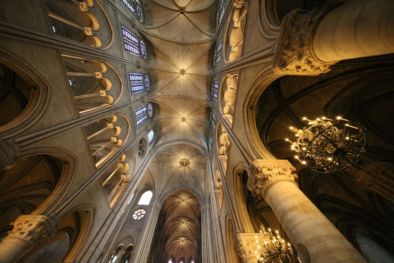 inside of a large cathedral with two massive stained windows