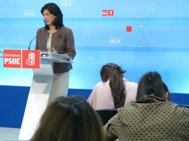 a woman is standing behind a podium with an electronic speaker