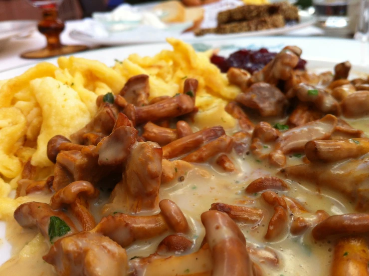 a plate of food with mushrooms and pasta