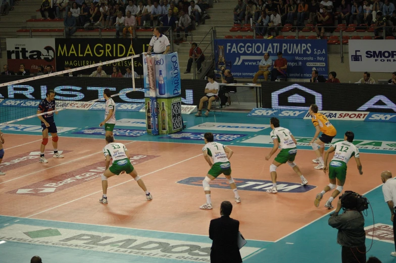 volleyball game being played in an indoor stadium