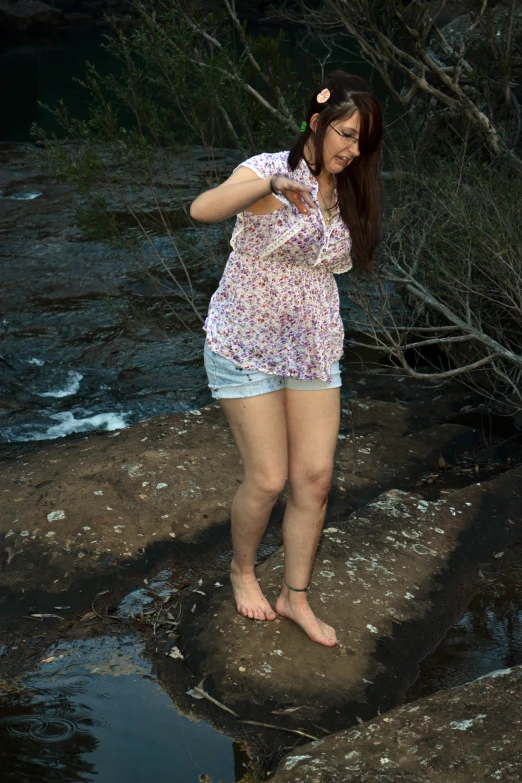 the young woman is barefoot on the shore