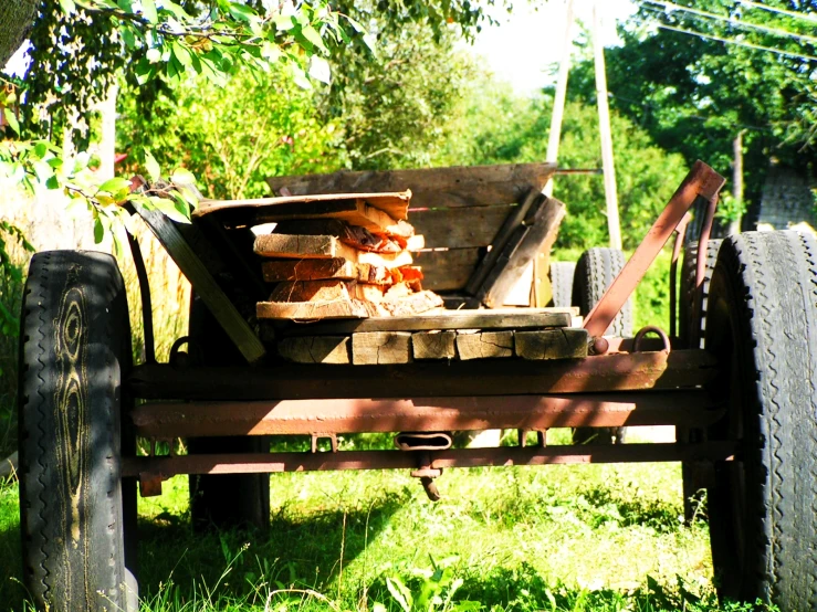 a wagon filled with logs and logs sitting in a park