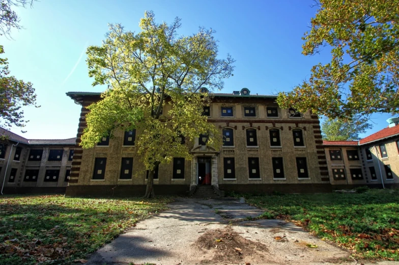 an old building with trees and windows around it