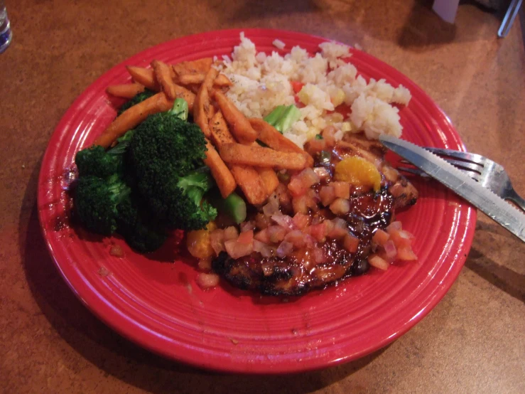 the food is on a red plate and ready to be eaten