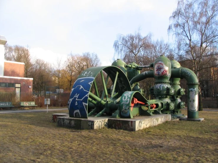 large, green machine that has been used for power to pump water into the river