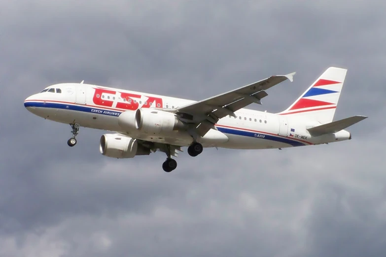 an airplane flying through the air on a cloudy day