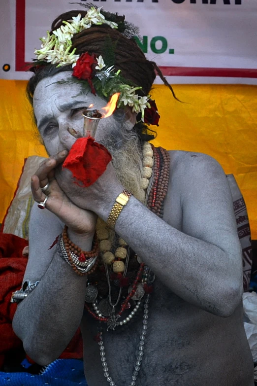 man with painted face and body in front of sign