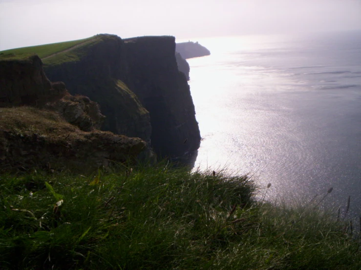 a cliff side overlooking a large body of water