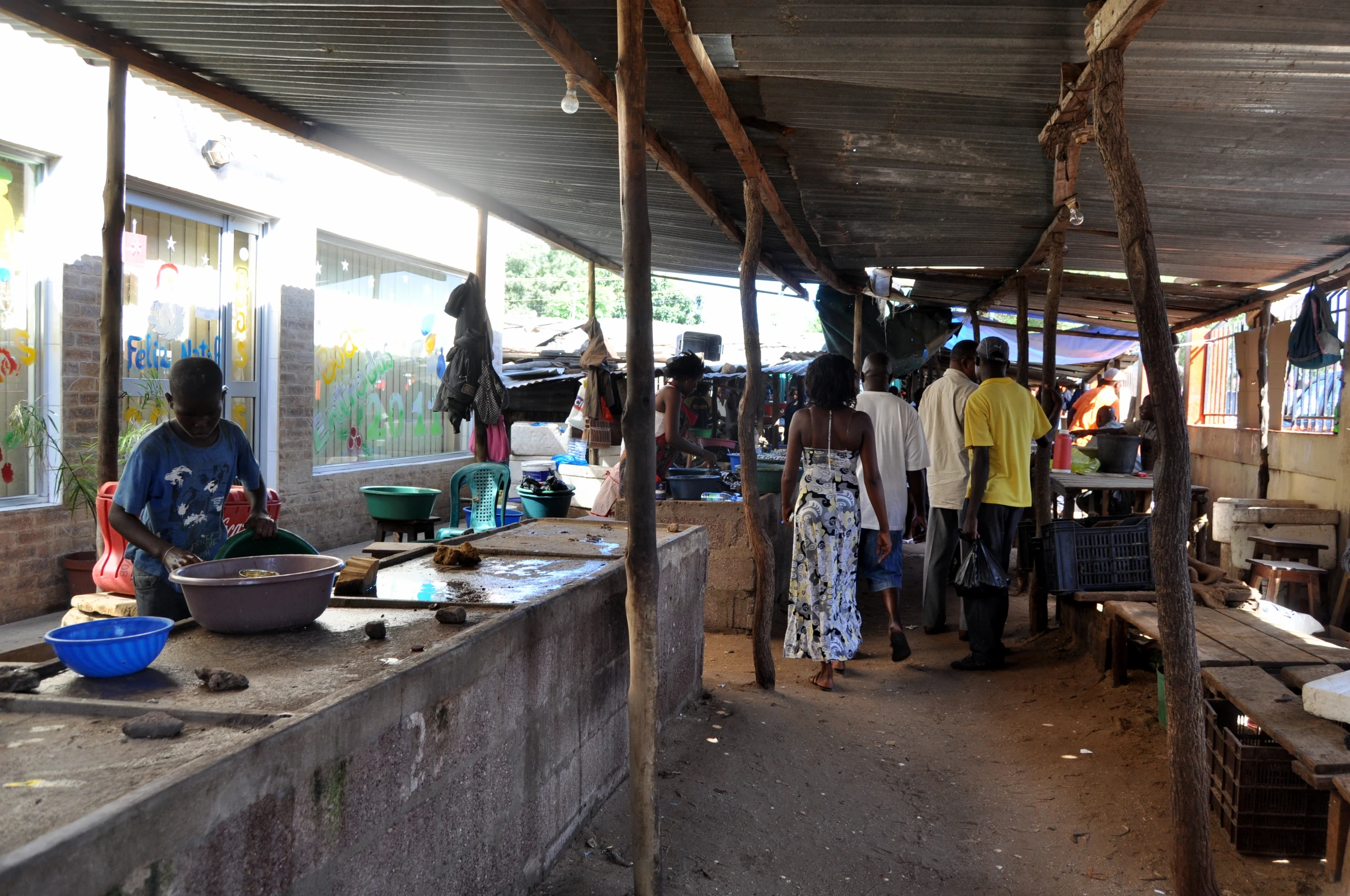 many people are shopping in a marketplace with people watching