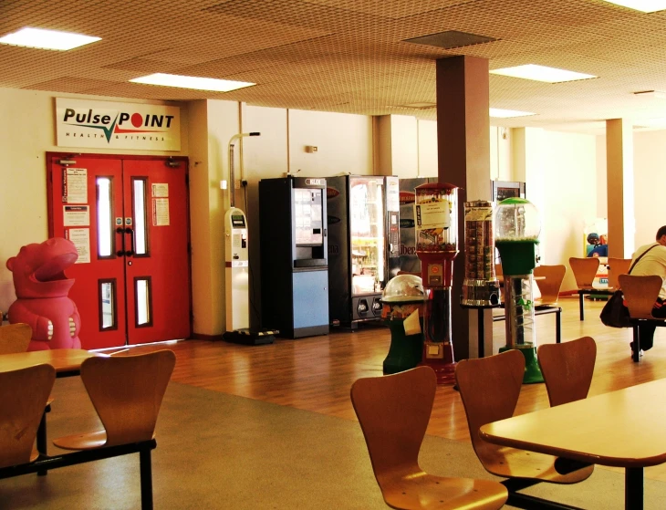 the inside of a cafeteria with many tables