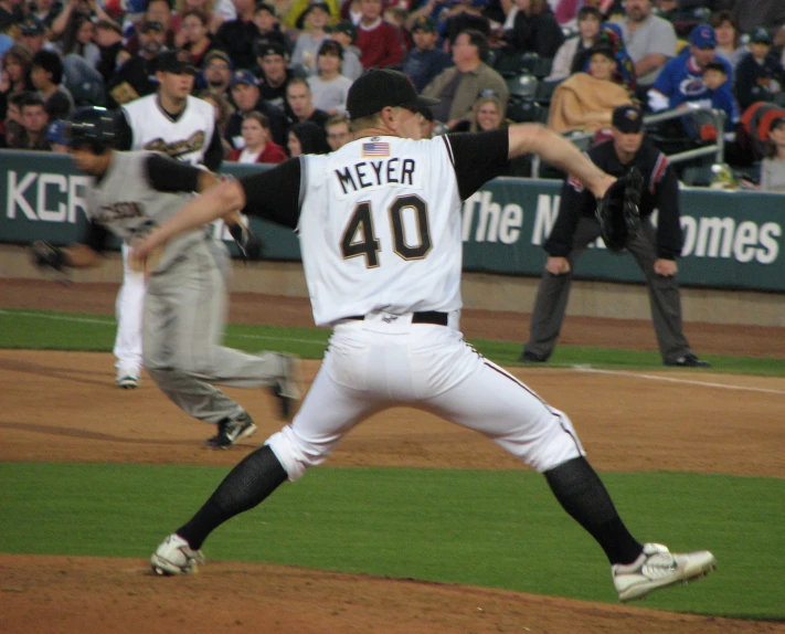 a pitcher on the mound throwing a ball with one hand