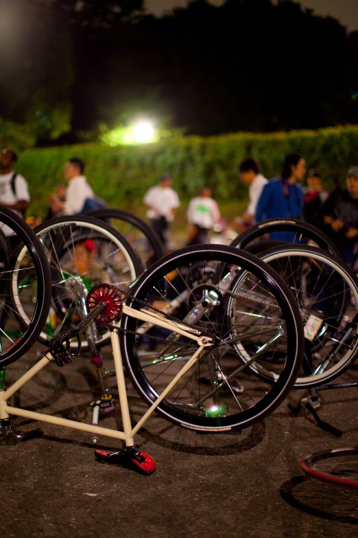 several bicycles parked on the ground while people watch