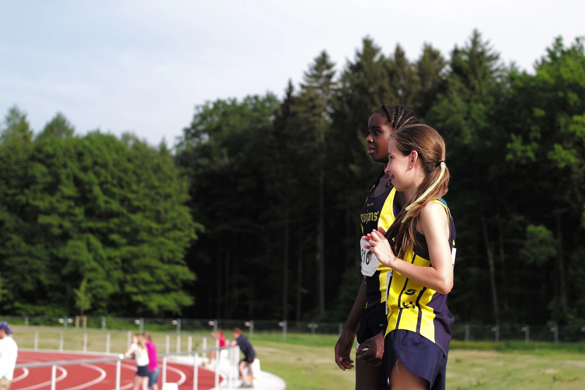 a woman and man running on the track