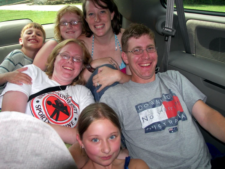 a group of people sitting in a vehicle together