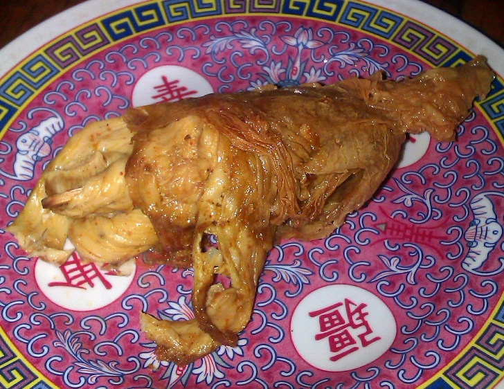 meat on a plate with chinese calligraphys