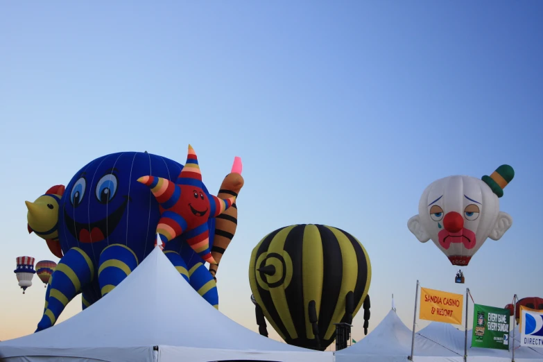 several colorful air balloons sitting near one another