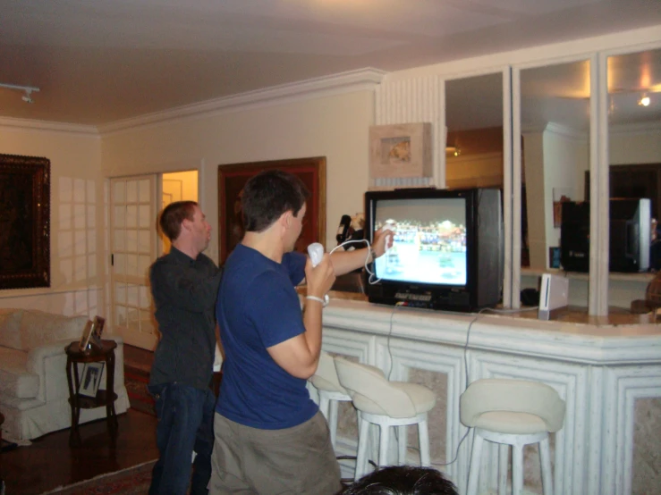 two men playing a game on the nintendo wii