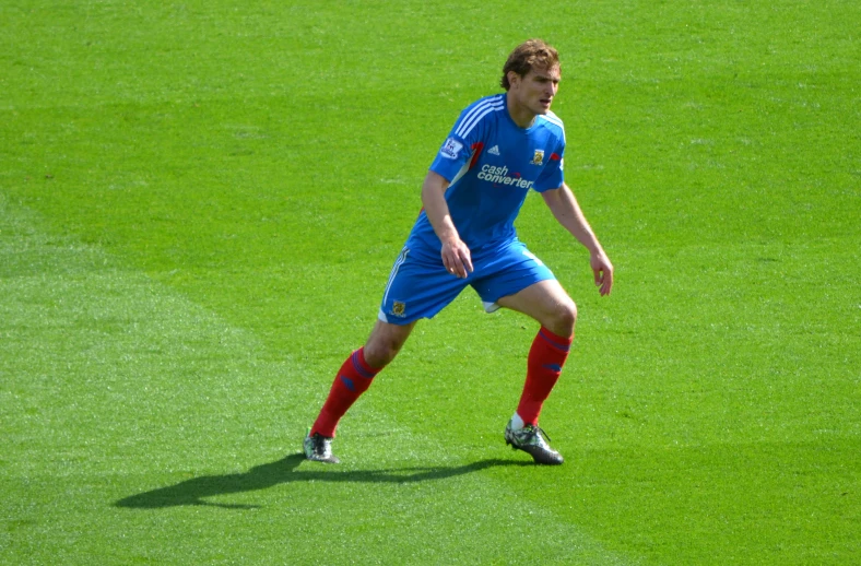 a soccer player is looking down the field
