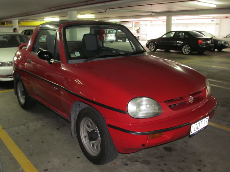 a red car parked in a parking garage