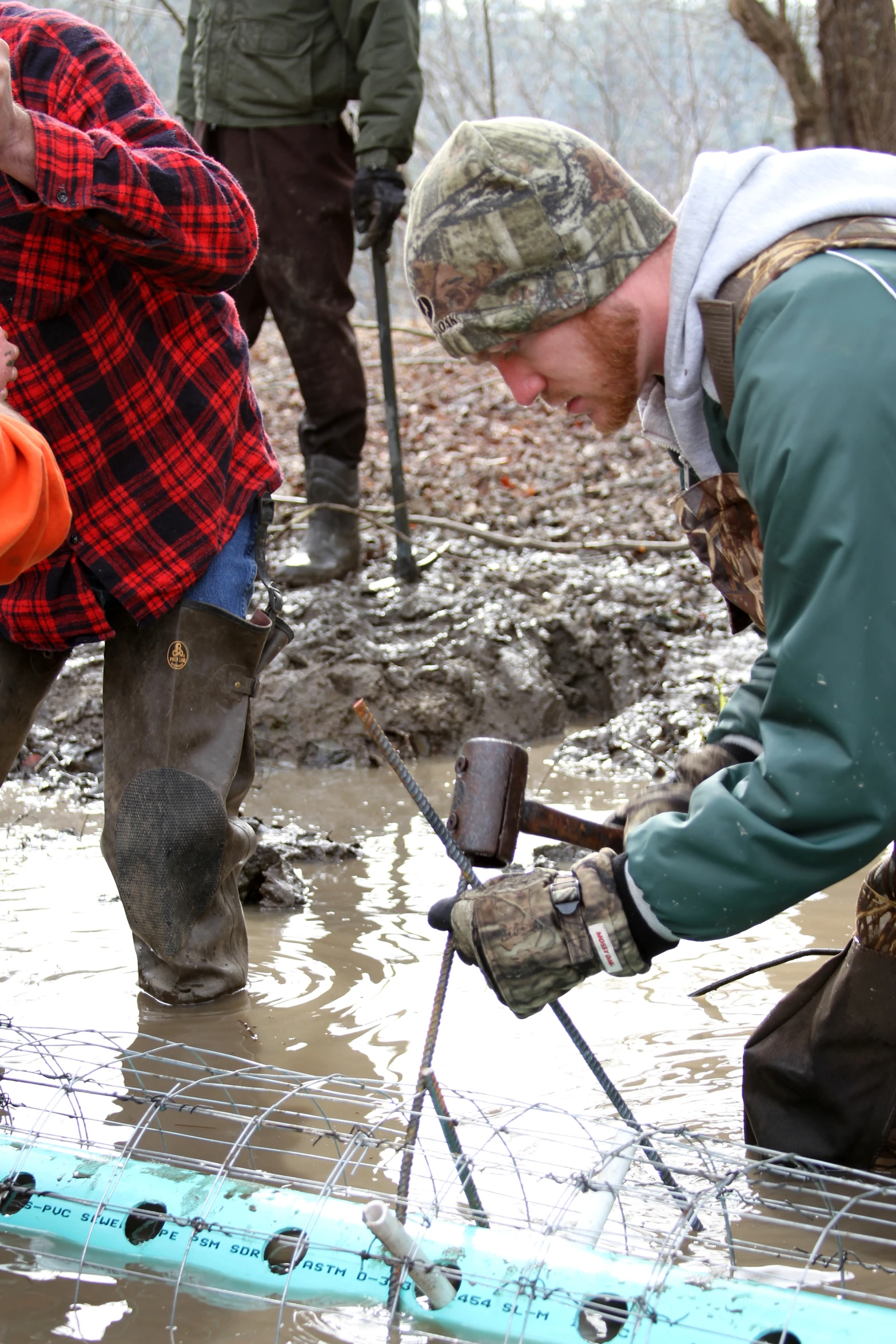 three people work together to build soing out of water