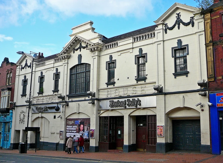 an old fashioned brick building with multiple windows