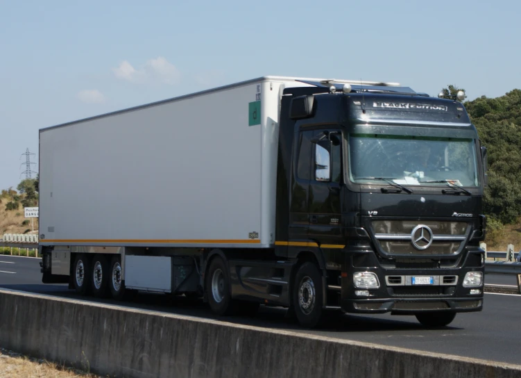 a large semi truck drives down the highway