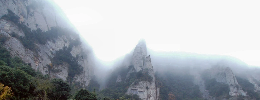 a group of mountains covered with a fog