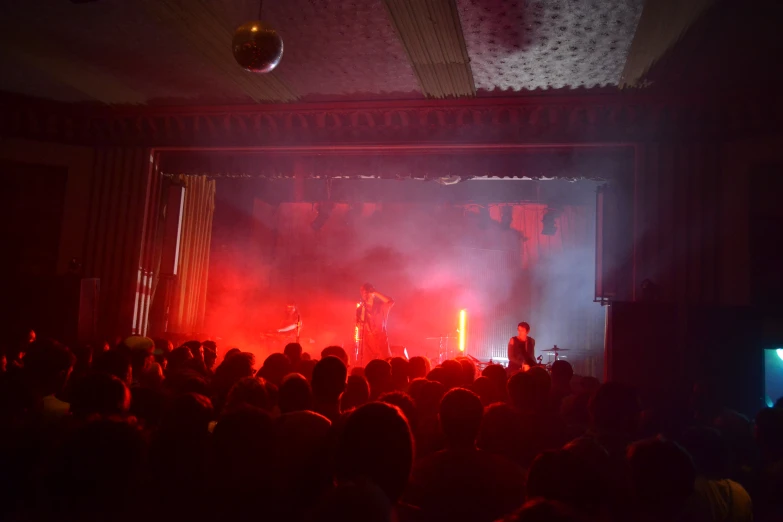 a group of people standing in front of a large audience