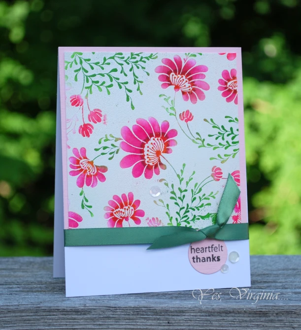 a card made with a floral background, which is attached to a card