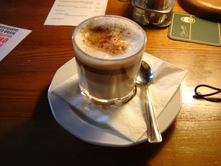 a cup of coffee sitting on a white plate