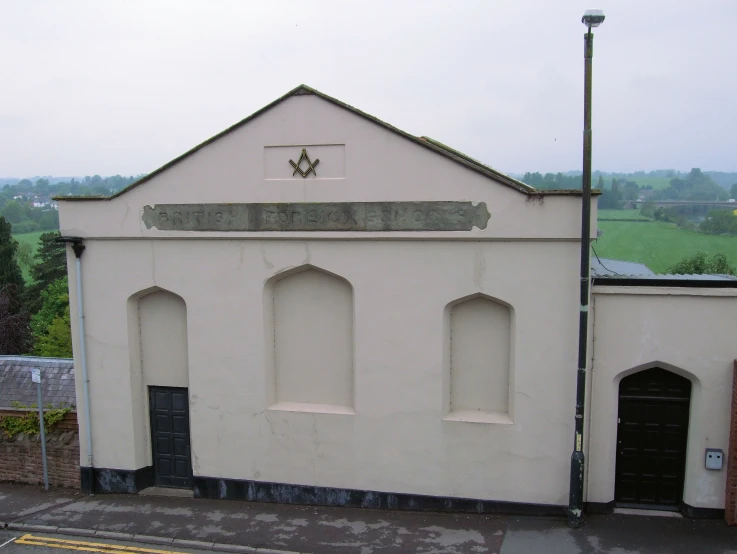 an old, white church building with a black door on the side