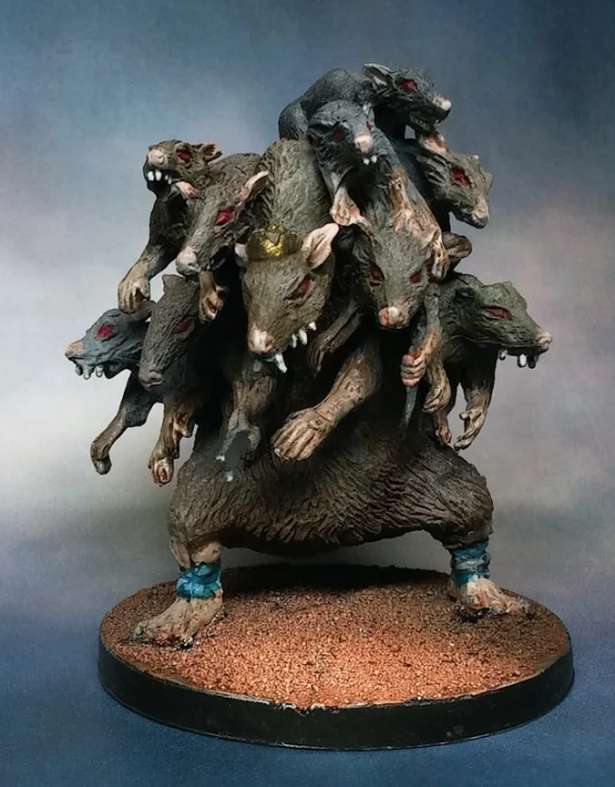 several zombie like animal models on top of a wooden base