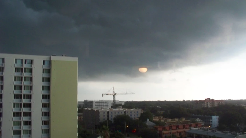 black storm clouds roll in over a city skyline