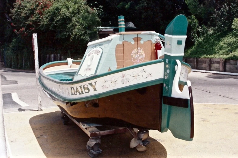 the boat sits parked on the side of the road