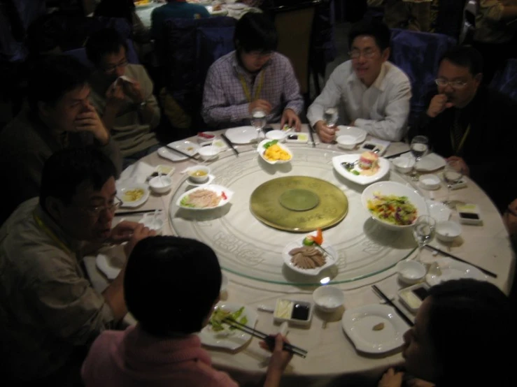 a round table with many people around it