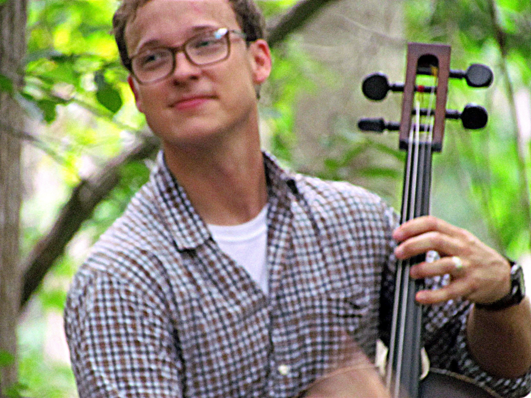 a person with glasses and a violin in his hands