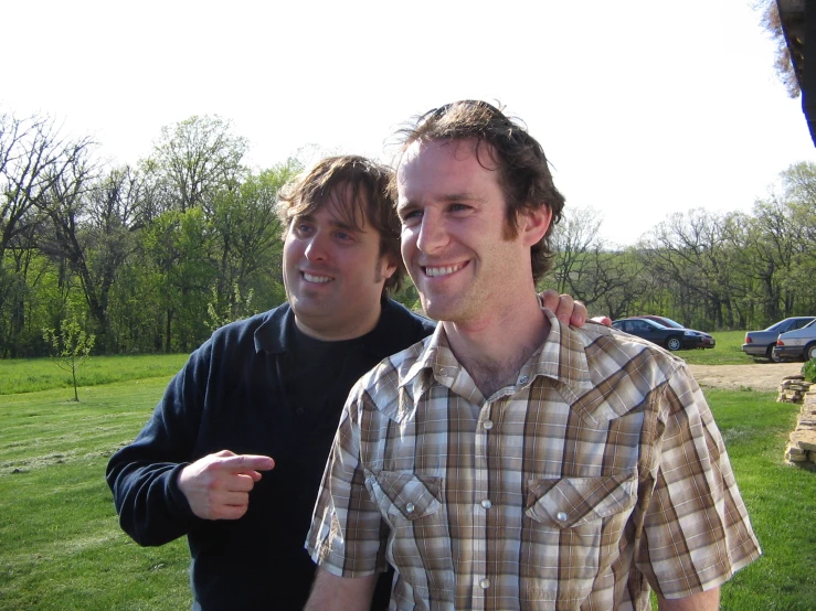 two guys in the park posing for a picture