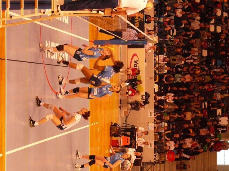 several female volleyball players in action at the court