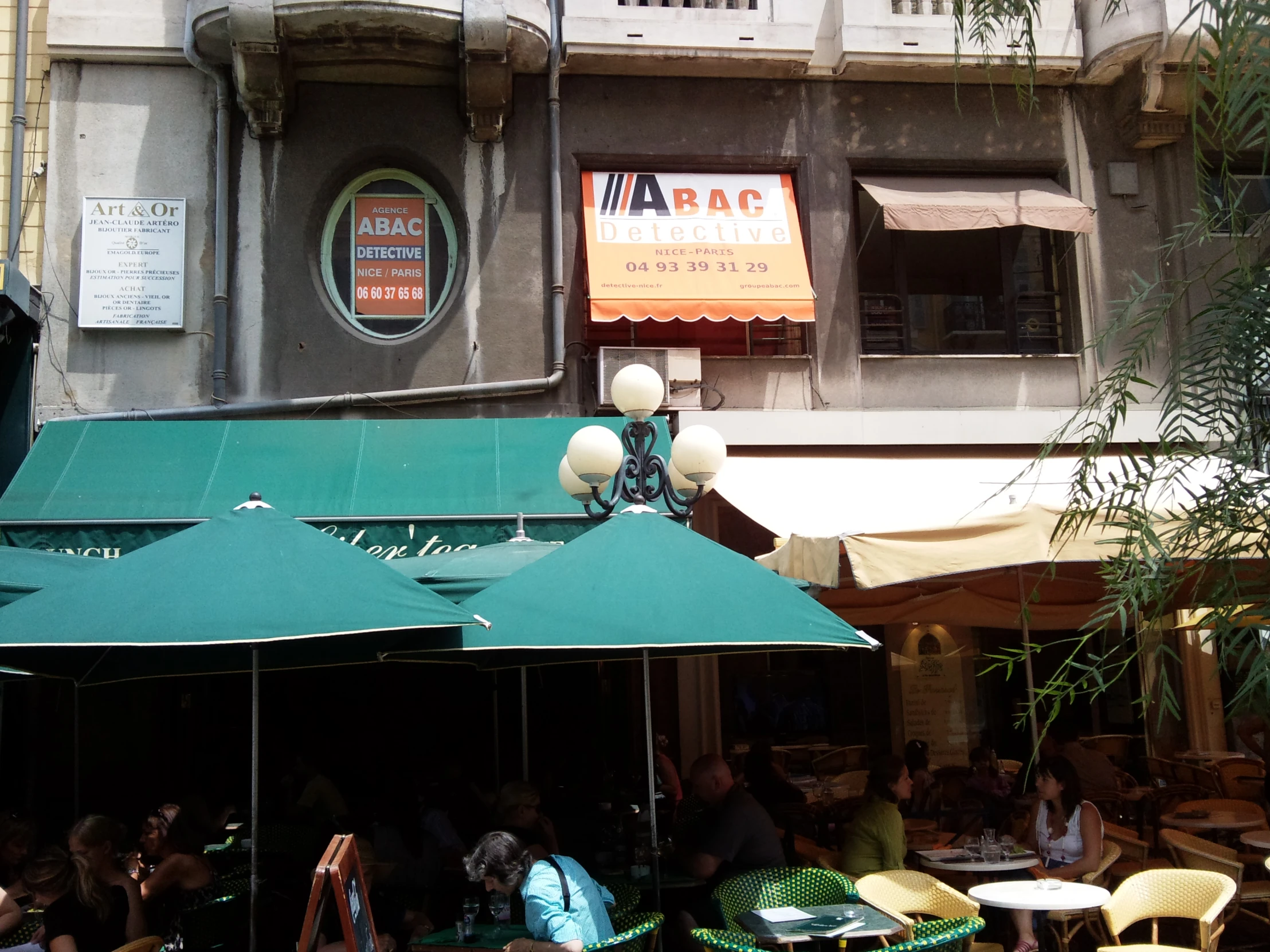a cafe with tables and chairs with a awning outside