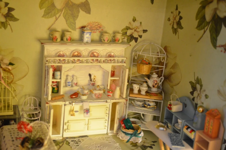 there is a small dollhouse kitchen with toys and furniture
