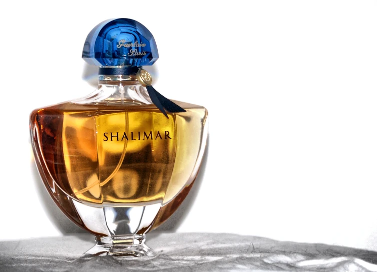 a bottle of shalimar is sitting on the table