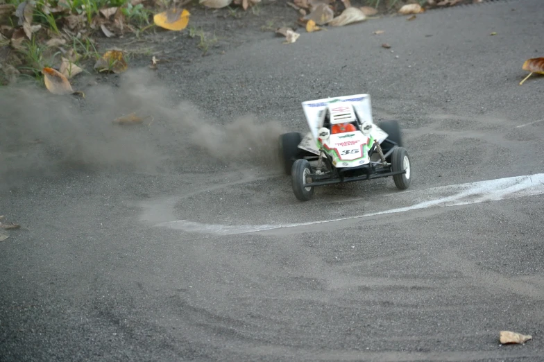 a small car with smoke coming from the front wheels