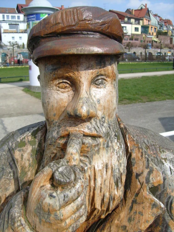 a statue of an old man with a beard, hat and a cane