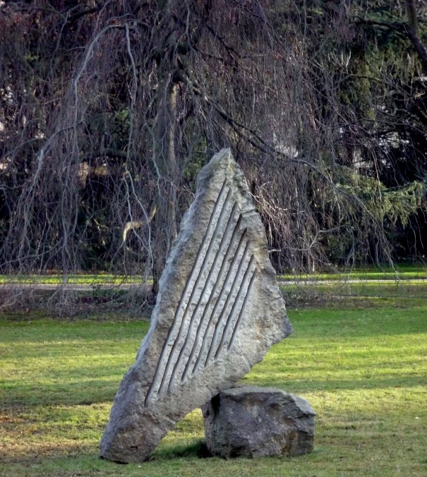 a large piece of rock sitting on top of grass