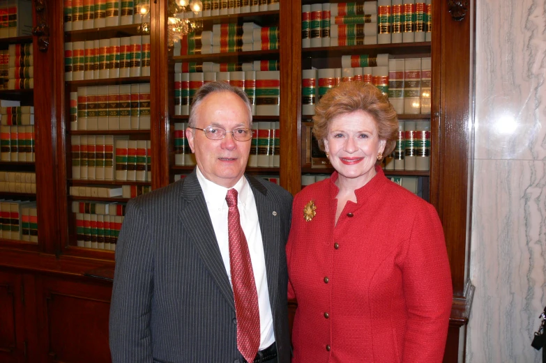 two men in business attire standing side by side