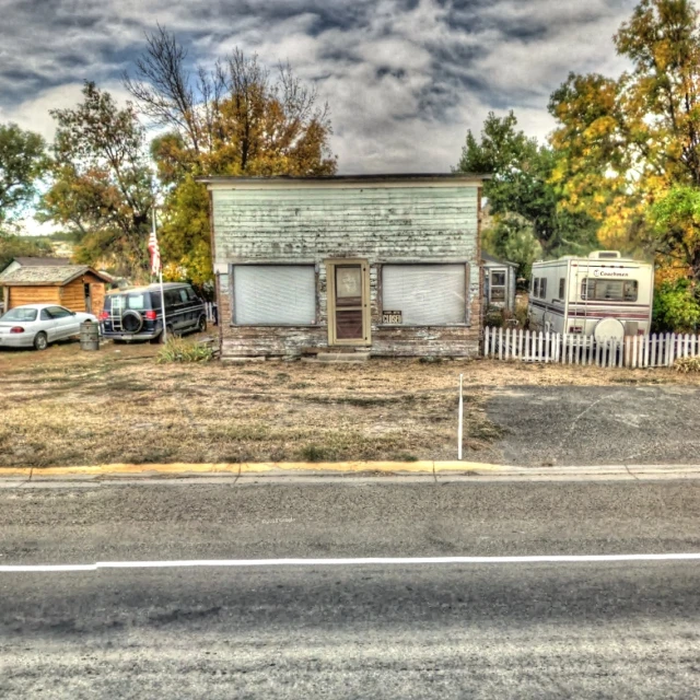 a big dirt lot with a big house