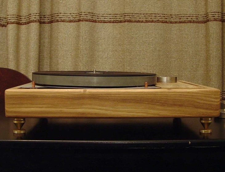 a modern turntable that is sitting on wooden legs