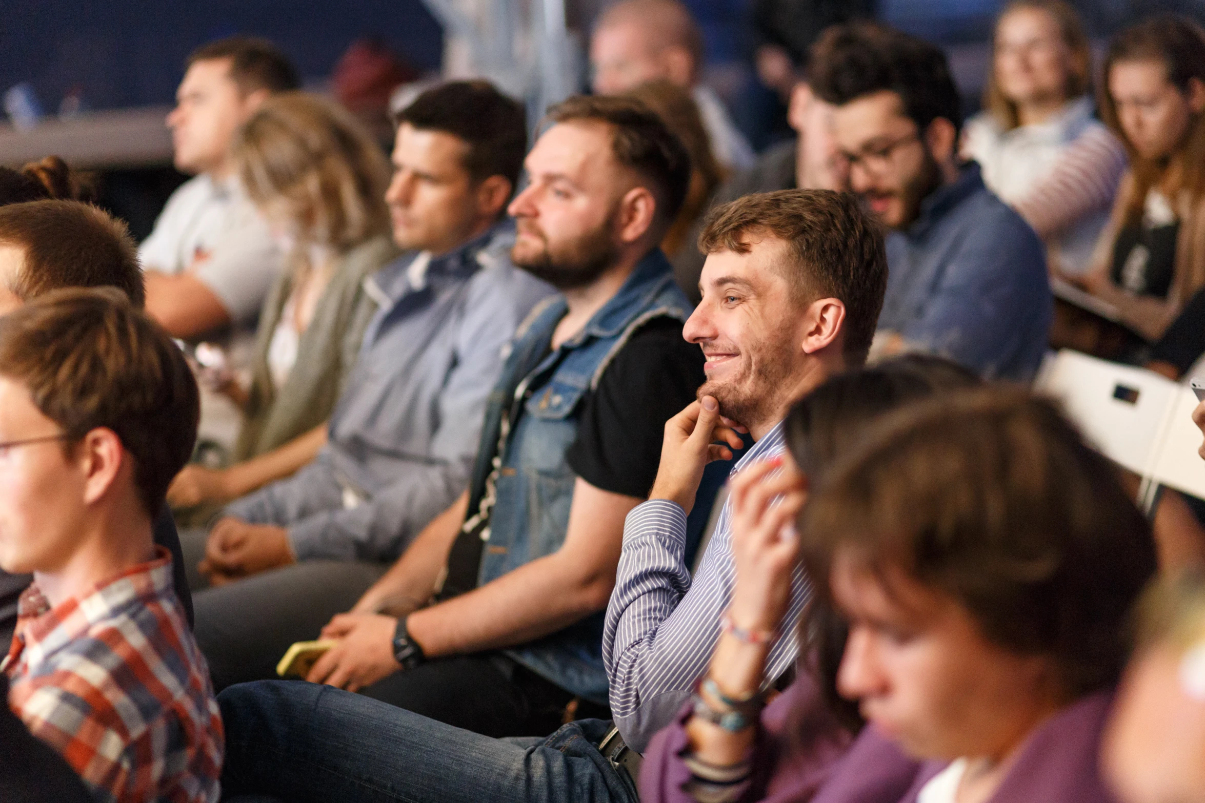 a group of people sitting in front of each other