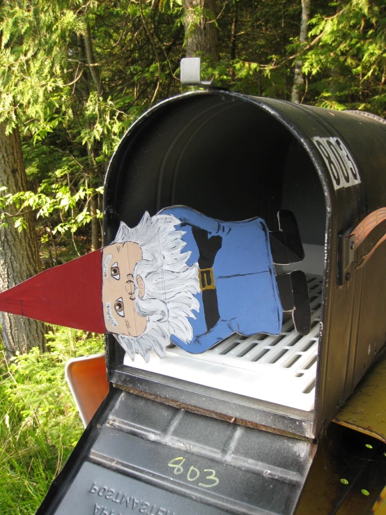 an old fashioned mailbox has an odd paper cut out of it