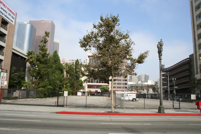 city street view with empty parking lot and lots of buildings